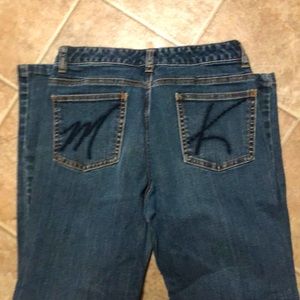 A pair of med blue, Michael Kors boot cut jeans